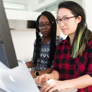 Woman Wearing Red and Black Checkered Blouse Using Macbook